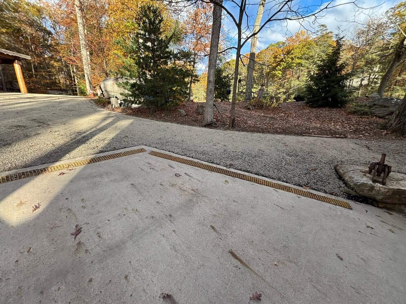 Wide concrete driveway with a channel drain running across its center