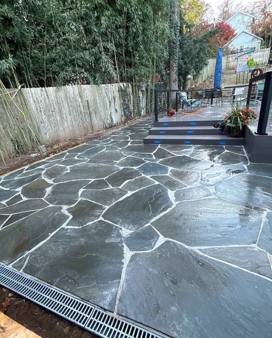 Flagstone patio with a discreet drainage channel along its edge