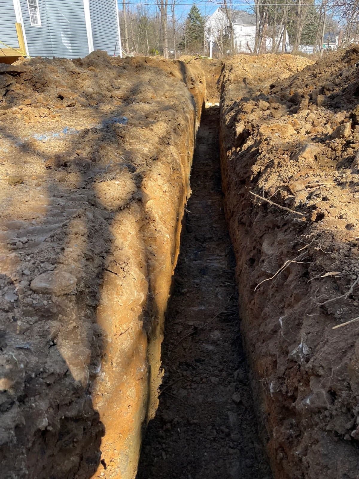Deep clean walled footing trench dug beside a framed addition